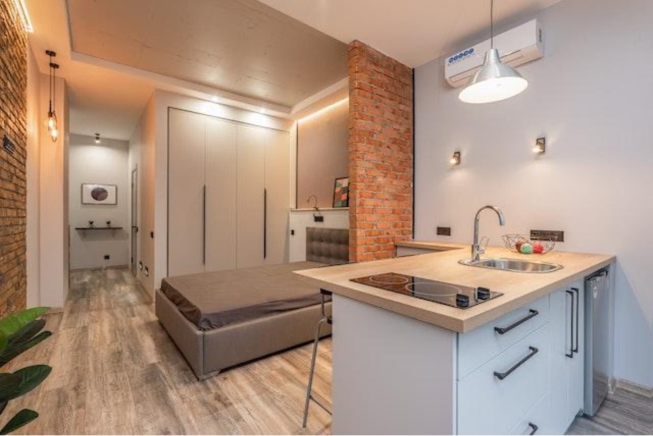 Kitchen and bedroom connected with open floor plan.