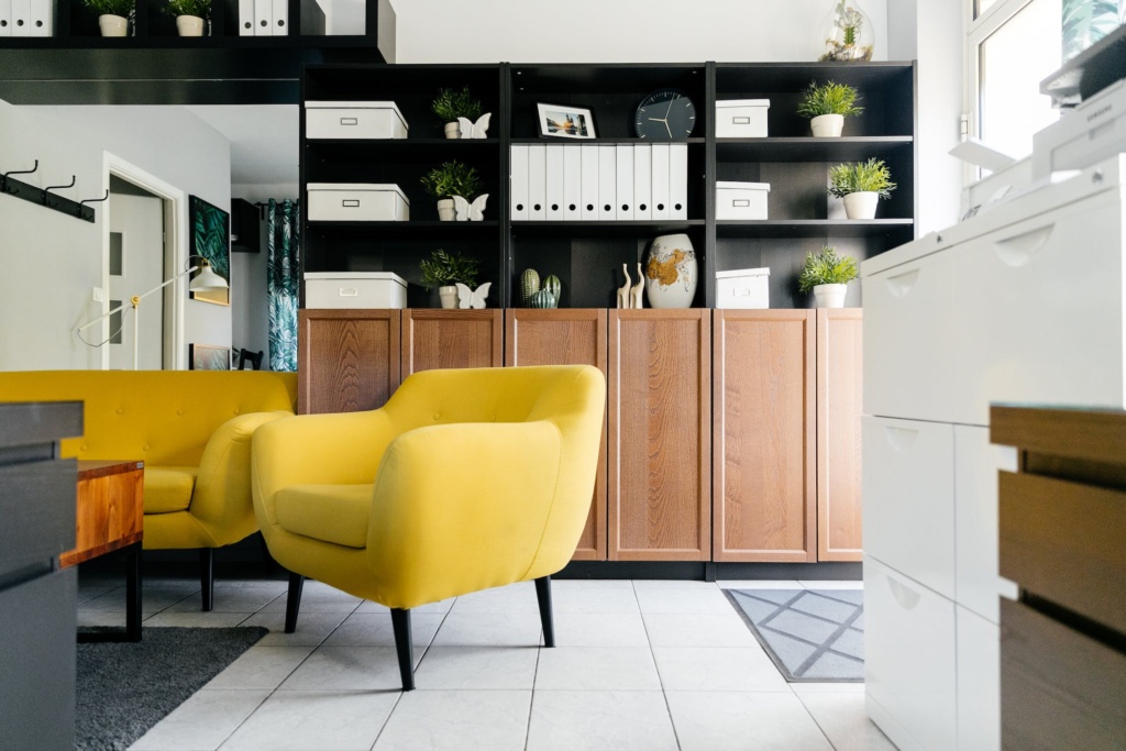 A yellow chair and couch in a living room.