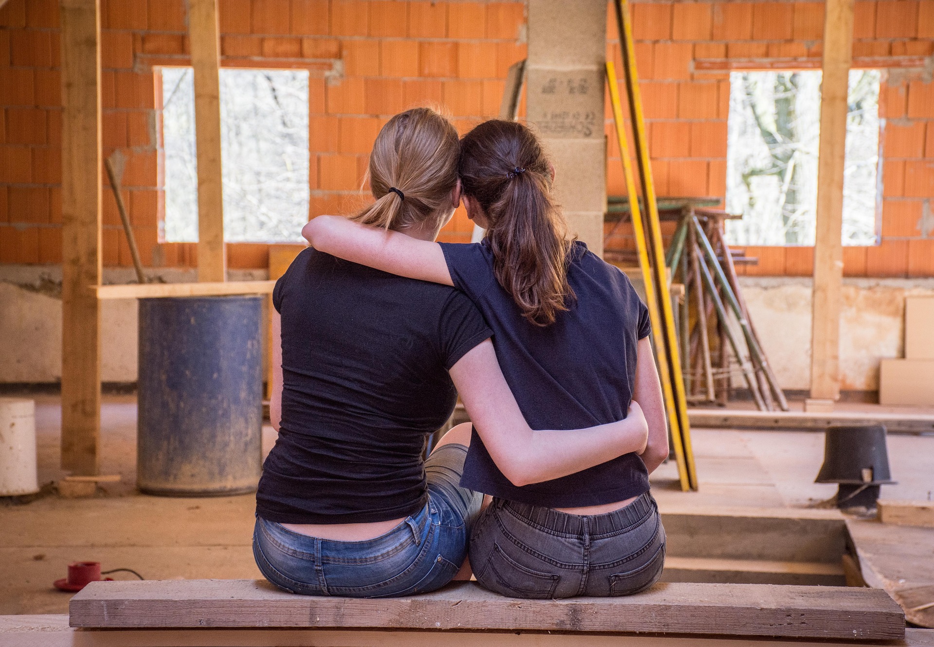 Two people embraced, enjoying the process of combining apartments in NYC